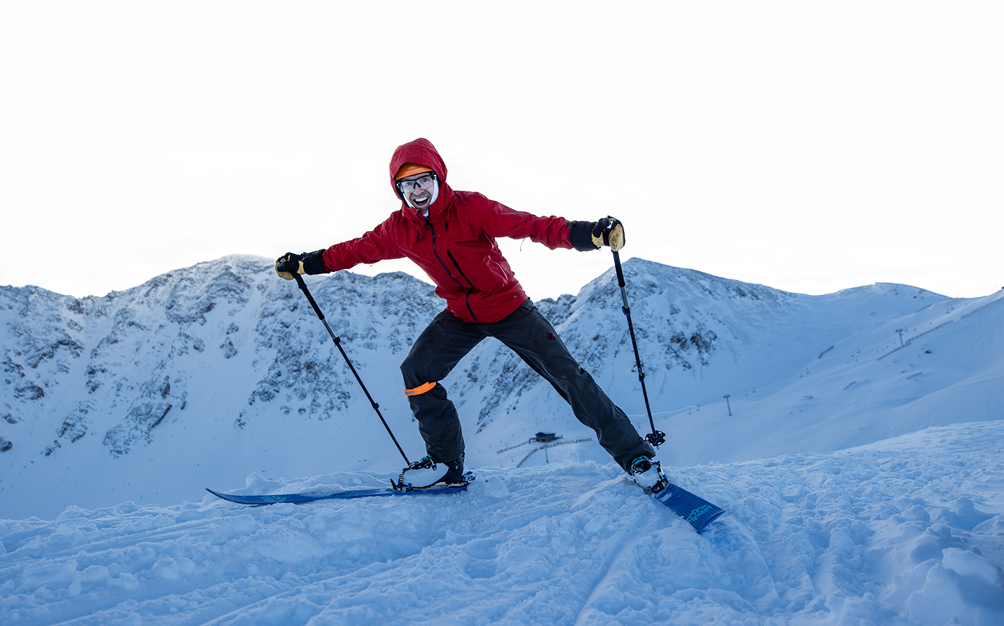 Smiling skier with mountains in the background